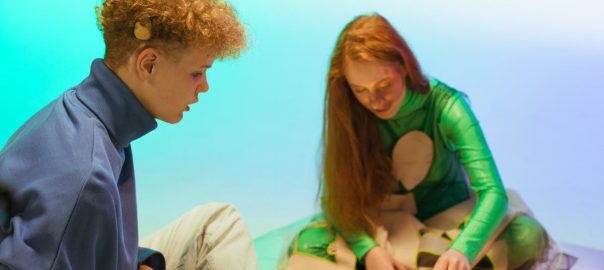 Two teenagers playing chess in a vibrant indoor setting, focusing on strategy and fun.